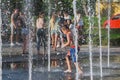 Uzhhorod, Ukraine, 30 June 2019: Children bathe in the fountain on a hot summer day Royalty Free Stock Photo