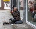 UZHHOROD, UKRAINE - JUNE 04, 2020: Image of homeless beggar man outdoors in Uzhhorod city