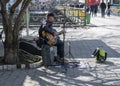 Uzhhorod, Ukraine - March 22, 2023: Street musician playing guitar outdoor in Uzhhorod