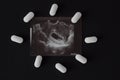 Uzi, pregnancy tablets and abortion, black background abortion