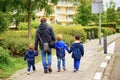 VAALS, NETHERLANDS - Aug 15, 2019: Man and three kids walking on a sidewalk
