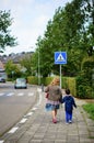 VAALS, NETHERLANDS - Aug 15, 2019: Woman and child walking on sidewalk