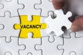 Vacancy text on missing jigsaw puzzle. Employment and hiring concept