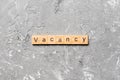 Vacancy word written on wood block. Vacancy text on cement table for your desing, concept Royalty Free Stock Photo