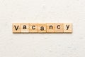 Vacancy word written on wood block. Vacancy text on cement table for your desing, concept Royalty Free Stock Photo