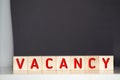 Vacancy word written on wood block. Vacancy text on wooden table for your desing, concept