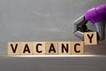Vacancy word written on wood block. Vacancy text on wooden table for your desing, concept