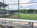 Vacant bleachers near empty baseball field with metal chain link in Dallas, Texas, USA Royalty Free Stock Photo