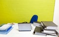 Vacant desk with laptop, folders and empty chair