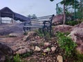 Vacant iron bench on a rocks in Madavoorpara Shiva Rock Temple in Kerala, India