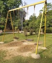 A vacant kid swing in a park