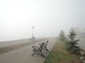 A vacant riverside bench on a foggy morning Royalty Free Stock Photo