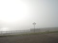 A vacant riverside bench on a foggy morning Royalty Free Stock Photo