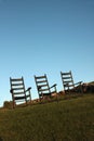 Vacant wooden chairs on grass