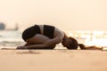 Vacation of Asian woman relaxing in yoga Child`s Pose stretching exercises muscle for warm up on the beach Royalty Free Stock Photo