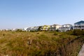 Summer beach cottages on the green sand grass Royalty Free Stock Photo