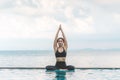 Vacation of Beautiful Attractive Asian woman relaxing in yoga lotus pose on the pool above the beach with beautiful sea in Tropica Royalty Free Stock Photo