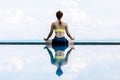 Vacation of Beautiful Attractive Asian woman relaxing in yoga lotus pose on the pool above the beach Royalty Free Stock Photo