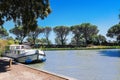 Vacation boat in Canal du Midi, family travel cruise by barge penichette, holidays in Southern France Royalty Free Stock Photo