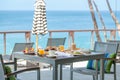 Vacation breakfast table at luxury restaurant or hotel cafe by sea in tropics Royalty Free Stock Photo