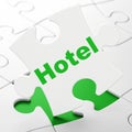 Vacation concept: Hotel on puzzle background