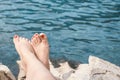 Vacation Concept. Tanning on the Beach. Woman`s Bare Feet over Sea background.Holidays at sea Royalty Free Stock Photo
