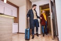 Vacation for couple. Young couple entering the hotel room together Royalty Free Stock Photo