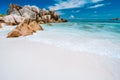 Vacation holiday. Ocean waves and granite rocks, perfect white sand, turquoise water and blue sky. Anse Cocos beach at Seychelles Royalty Free Stock Photo