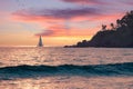 Vacation holidays background - summer beautiful seascape, pink sky at sunset, warm sea, sailboat on horizon, palm tree.