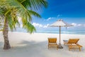 Vacation holidays background wallpaper, two deck chairs under tent on beach. Tropical Holiday Banner. Royalty Free Stock Photo