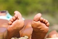 Vacation holidays. Woman feet closeup of girl relaxing on beach on sunbed enjoying sun on sunny summer day Royalty Free Stock Photo