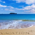 VACATION insctiption under the sun drawing on wet beach sand wit Royalty Free Stock Photo