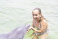 Vacation Lifestyle -Happy teenager hugging a dolphin