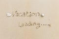 Vacation loading writing on the sand, message on the sand background Royalty Free Stock Photo