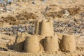 Vacation memory, Abandoned sandcastle on seaside resort beach. Royalty Free Stock Photo