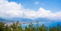 Vacation near sea. Very beautiful day on sea, sunny weather, mountains and blurred coast town on the background Royalty Free Stock Photo