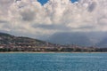 Vacation near sea. Very beautiful day on sea, sunny weather, mountains and blurred coast town on the background Royalty Free Stock Photo