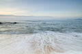 Beautiful tropical beach, soft wave hitting sandy beach under brighter sunny day Royalty Free Stock Photo