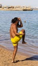 Vacation on the red sea. Animator in yellow shorts, conducts fitness training for tourists.