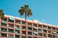 Vacation rental apartment building balconies and palm tree on sunny day Royalty Free Stock Photo