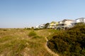 Vacation rental cottages on the green sand dunes Royalty Free Stock Photo