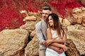 Vacation romantic love middle aged happy couple hug and standing at sand rock having fun and relaxing together on the beach Royalty Free Stock Photo