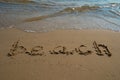 Vacation on the sand beach concept. Beach words written into the sand on the beach. Royalty Free Stock Photo