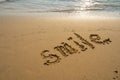 Vacation on the sand beach concept. Smile words written into the sand on the beach at Rayong, Thailand Royalty Free Stock Photo