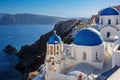 Vacation on Santorini island, Travel to Greece. The blue dome of the white church near the sea and caldera. Royalty Free Stock Photo