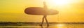 Vacation Silhouette Of A Surfer Carrying His Surf Board Home At Sunset With Copy Space BANNER, long format Royalty Free Stock Photo