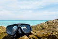 Vacation Start Here Concept, Scuba Diving Equipment On The Sea Rock of The Beach at The Corner with Crystal Clear Sea and Sky