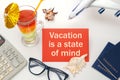 Vacation is a state of mind - the inscription on the notebook, cocktails, plane, documents