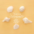 vacation and summer image with seashells over yellow wooden background. Royalty Free Stock Photo