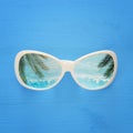 vacation and summer image with sunglasse over blue wooden background.